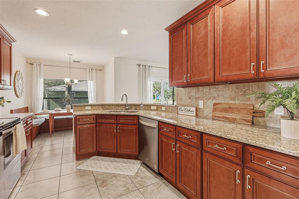 634 Carmel Road Venice, FL 34293 - Photo 16 of 67 a kitchen with stainless steel appliances granite countertop wooden cabinets a sink and dishwasher