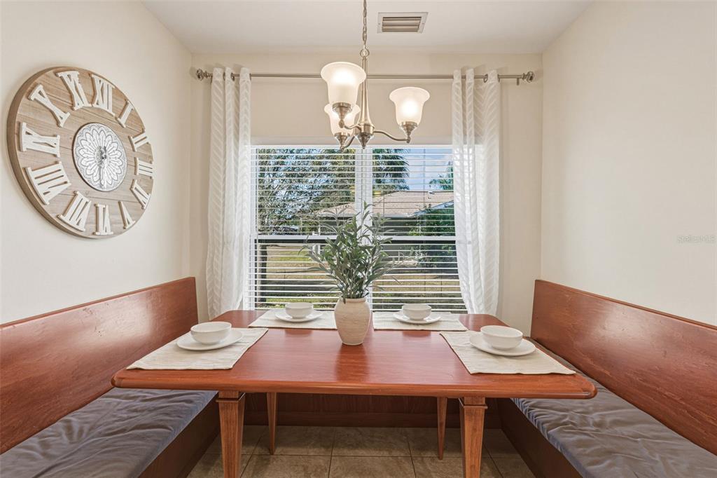 634 Carmel Road Venice, FL 34293 - Photo 20 of 67 a view of a dining room with furniture and wooden floor
