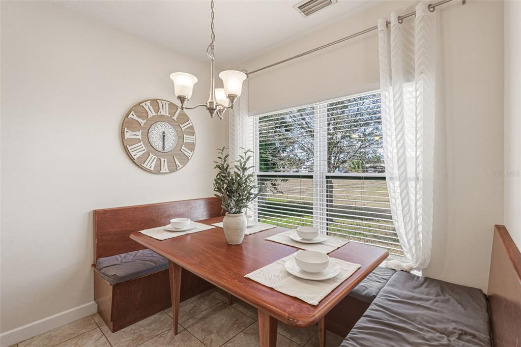 634 Carmel Road Venice, FL 34293 - Photo 21 of 67 a view of a dining room with furniture window and wooden floor
