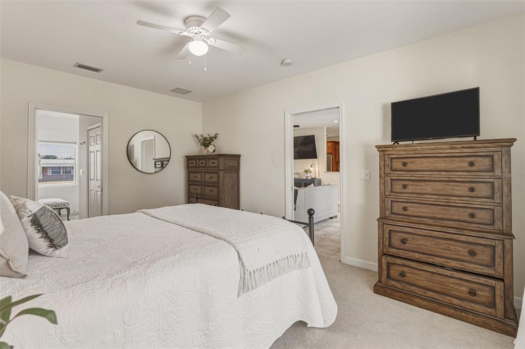 634 Carmel Road Venice, FL 34293 - Photo 25 of 67 a bedroom with a bed and a flat screen tv
