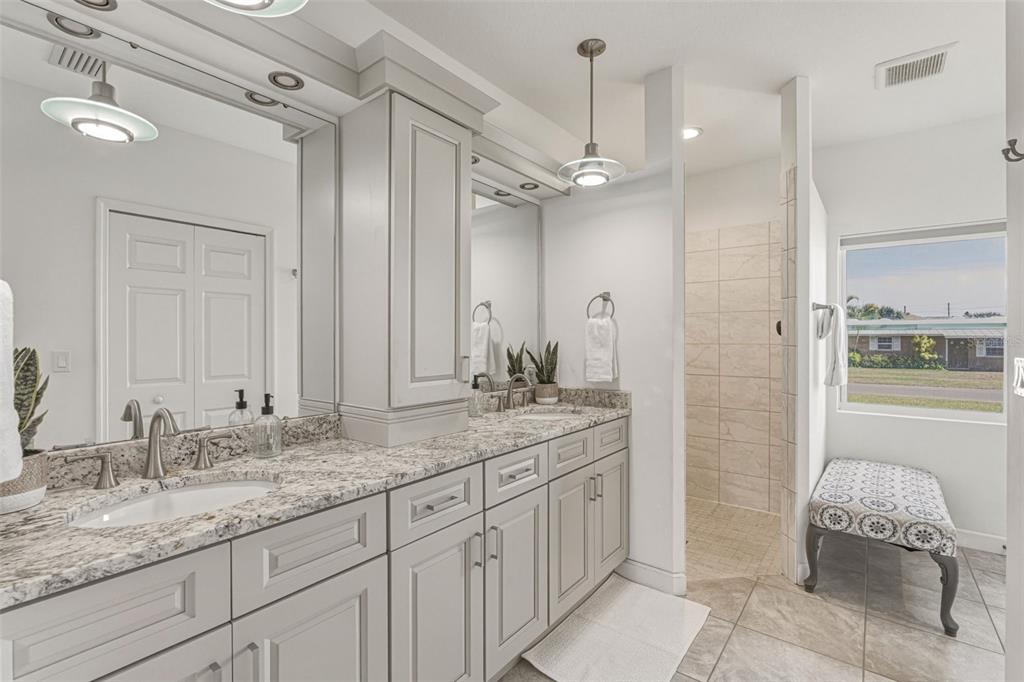 634 Carmel Road Venice, FL 34293 - Photo 28 of 67 a bathroom with a granite countertop sink mirror and a shower