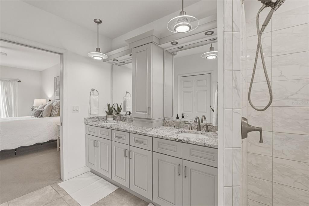 634 Carmel Road Venice, FL 34293 - Photo 29 of 67 a bathroom with a double vanity sink mirror and shower