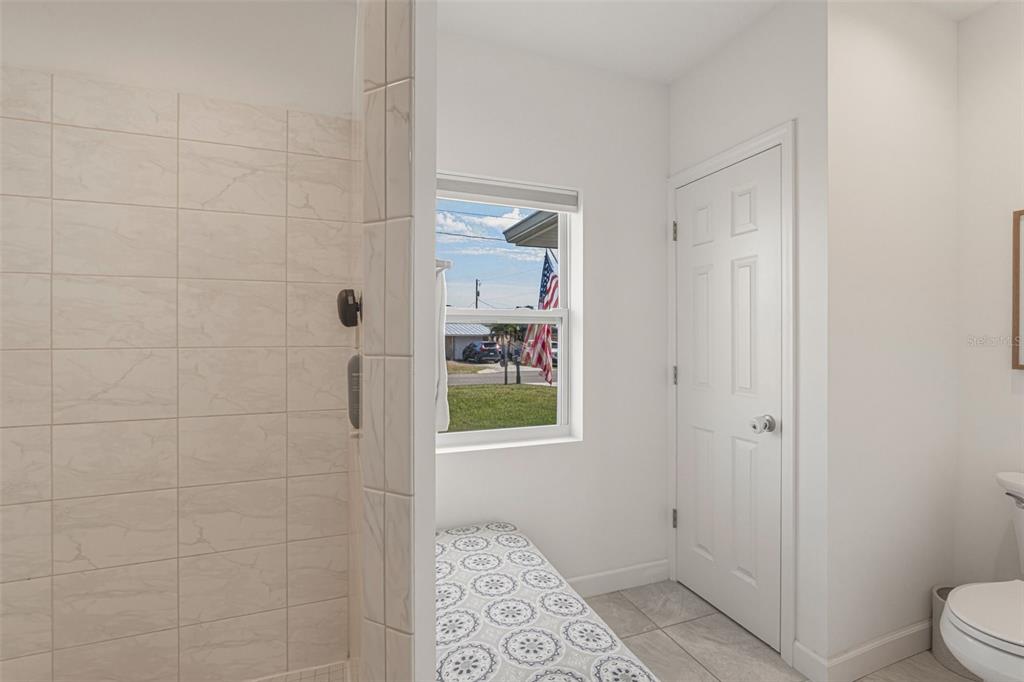 634 Carmel Road Venice, FL 34293 - Photo 30 of 67 a bathroom with a window and a toilet