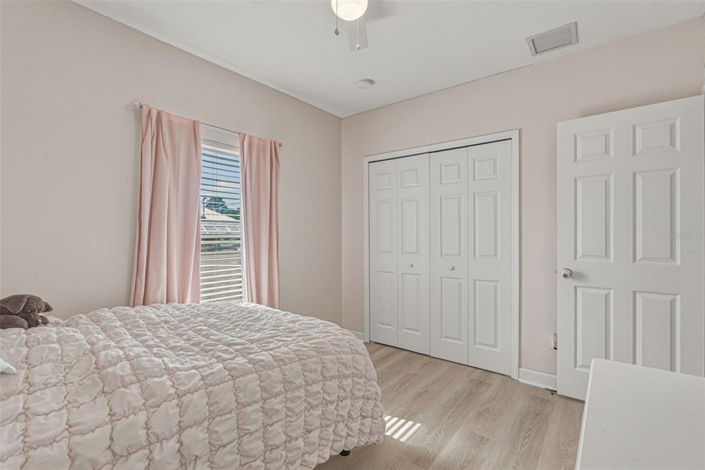 634 Carmel Road Venice, FL 34293 - Photo 34 of 67 a bedroom with a bed and a chandelier