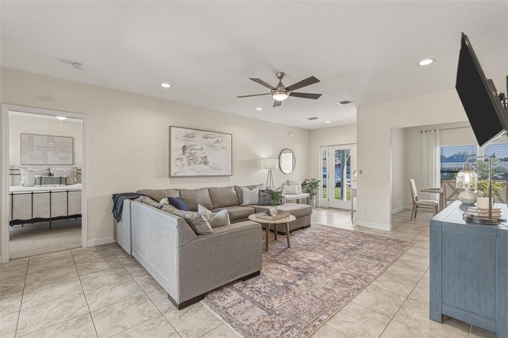 634 Carmel Road Venice, FL 34293 - Photo 8 of 67 a living room with furniture a flat screen tv and a fireplace