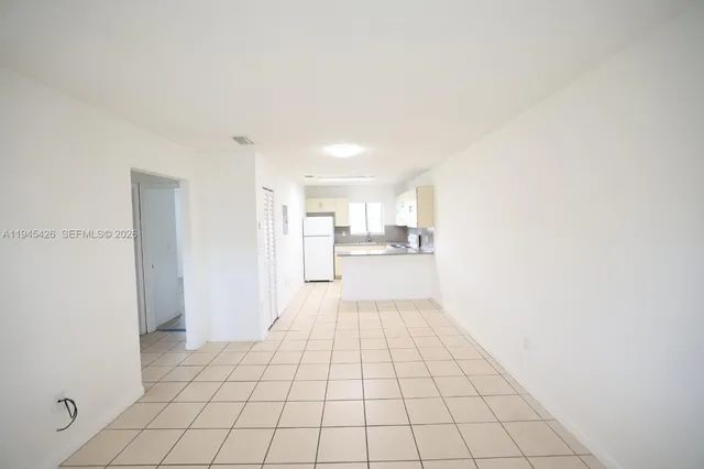 a view of a kitchen with white cabinets