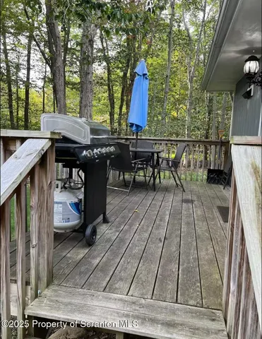a view of outdoor sitting area with furniture and wooden floor