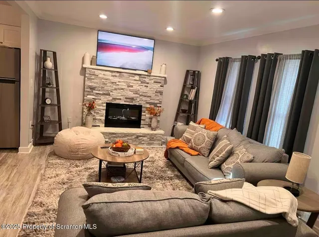 a living room with furniture and a fireplace