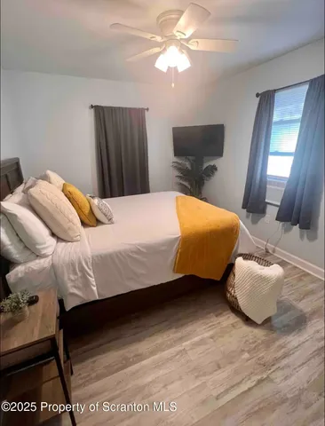 a bedroom with a bed and dresser with mirror