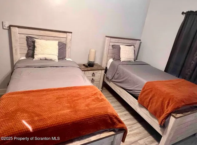 a bedroom with bed and window