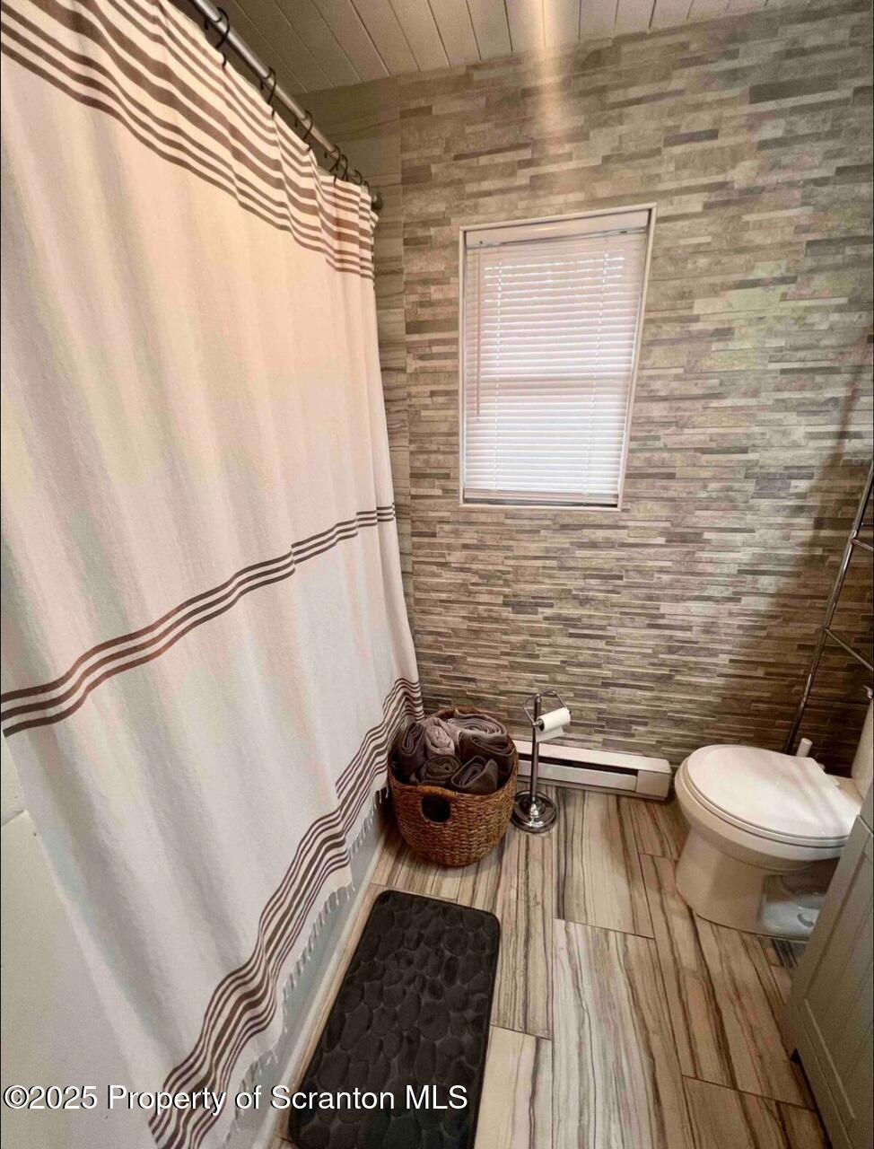 103 Orchard Lane Tobyhanna, PA 18466 - Photo 9 of 12 a bathroom with a granite countertop window a toilet and a shower