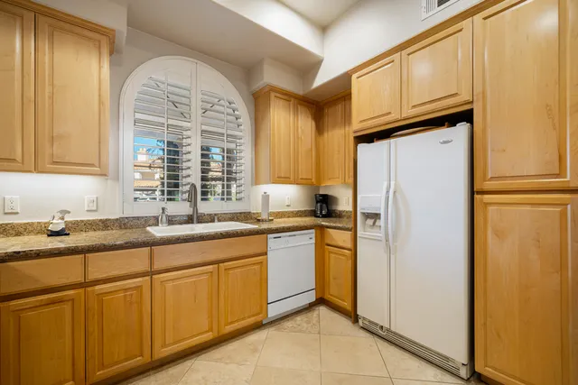 a kitchen with stainless steel appliances granite countertop a refrigerator sink and cabinets
