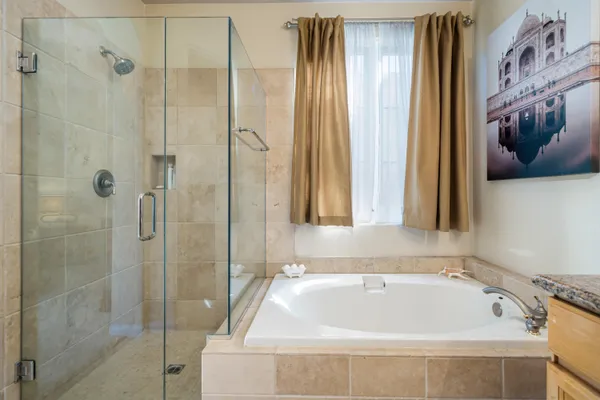 a bathroom with a tub and shower