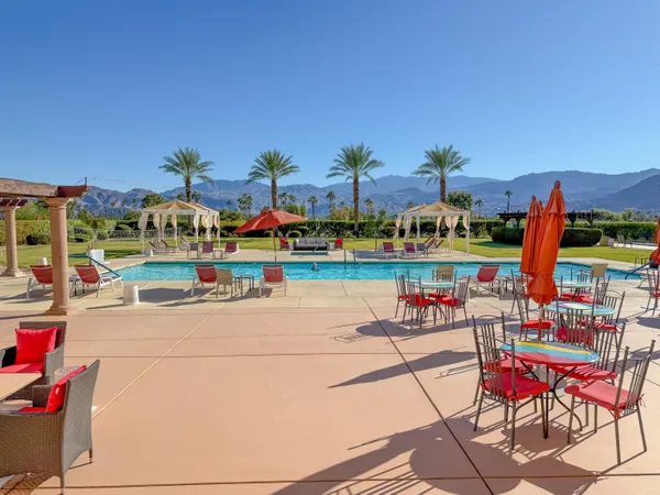 a view of a patio with a table and chairs