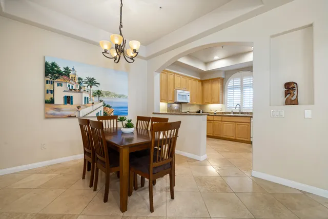 a view of a dining room with furniture and a chandelier