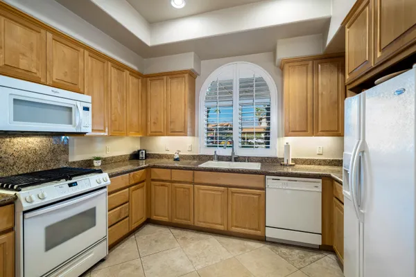 a kitchen with a sink stove and microwave