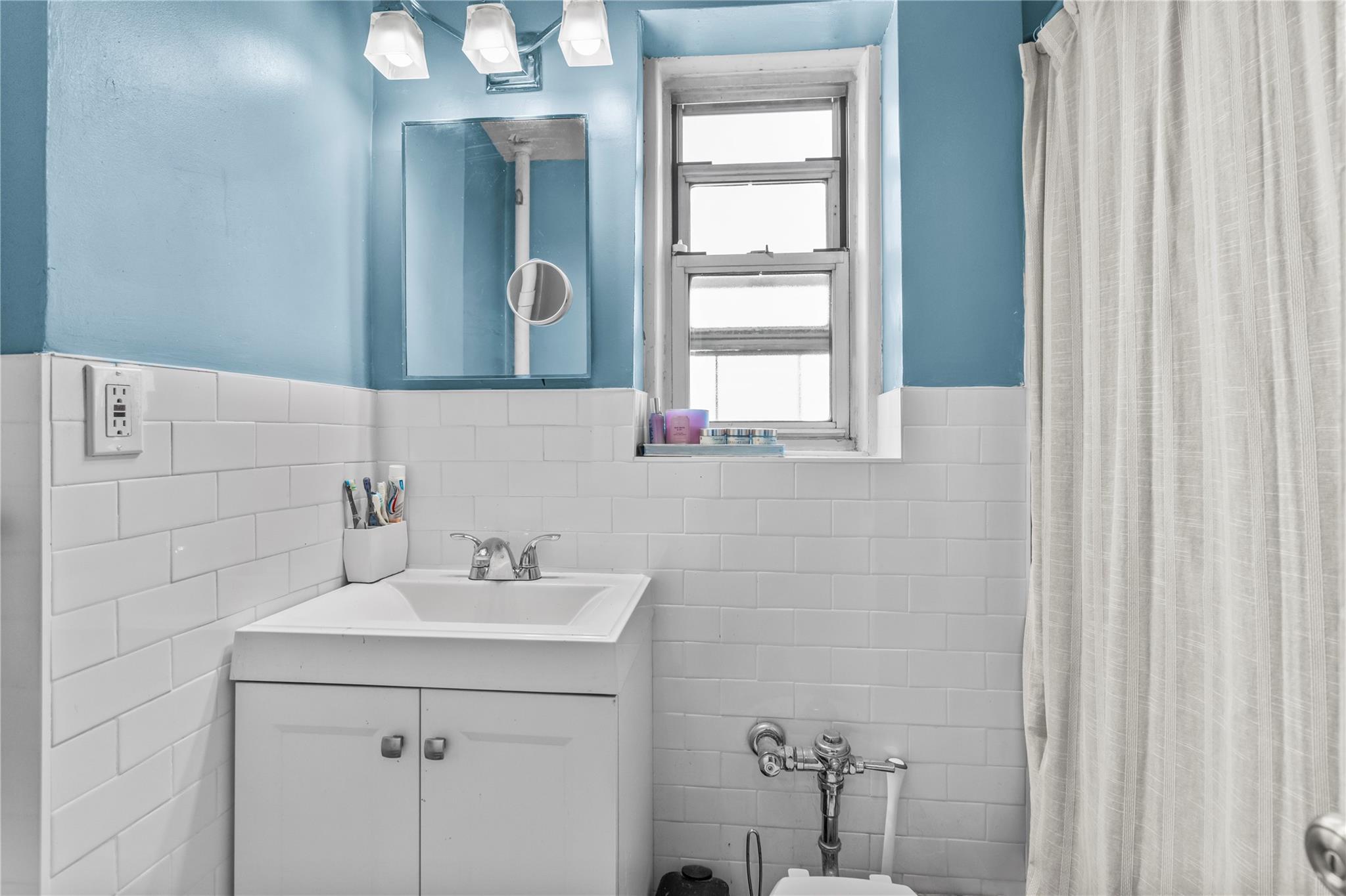 60 Locust Avenue, Unit 610 New Rochelle, NY 10801 - Photo 14 of 22 a bathroom with a sink vanity and a mirror