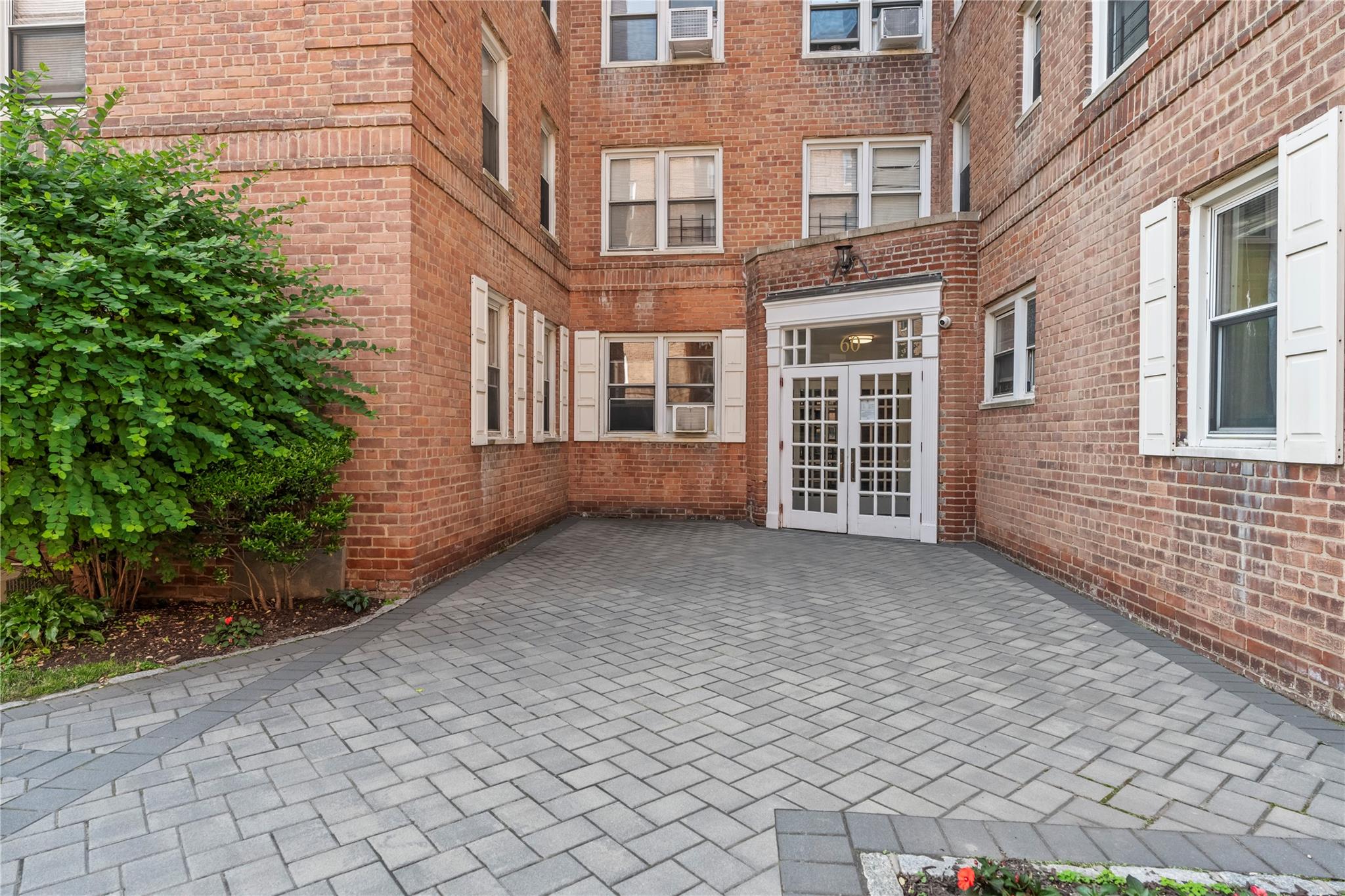 60 Locust Avenue, Unit 610 New Rochelle, NY 10801 - Photo 18 of 22 a view of a building with a yard