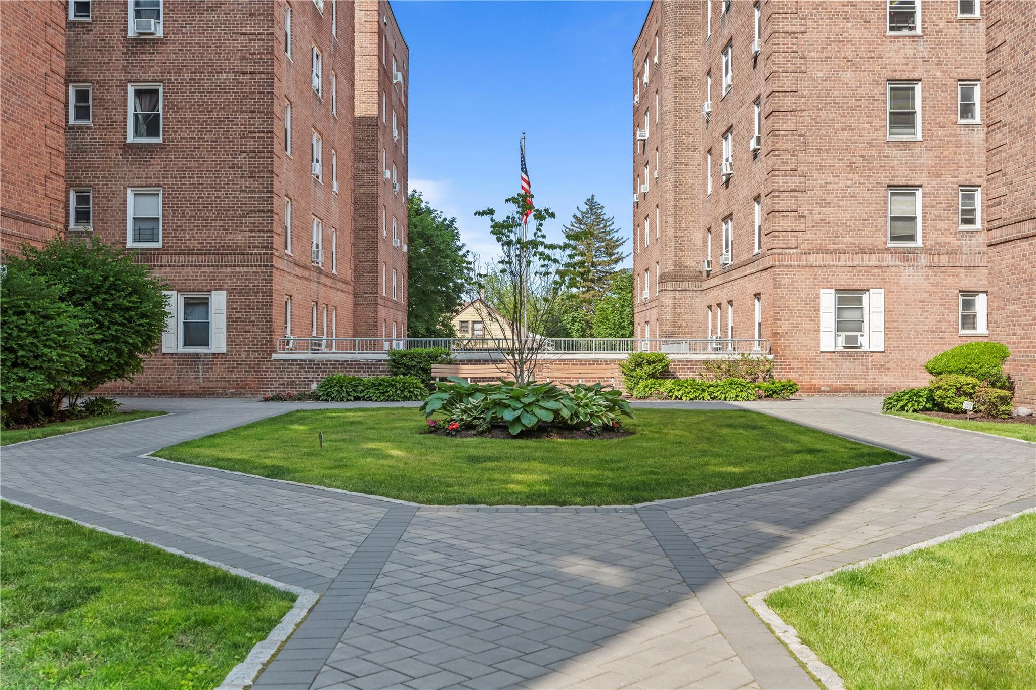 60 Locust Avenue, Unit 610 New Rochelle, NY 10801 - Photo 19 of 22 front view of a brick house with a yard