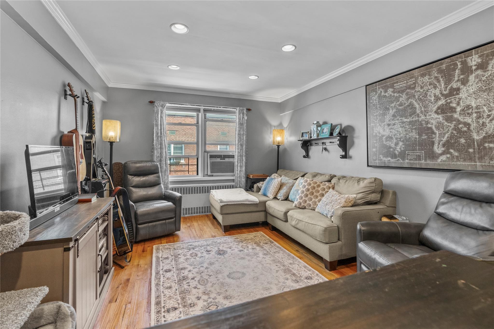 60 Locust Avenue, Unit 610 New Rochelle, NY 10801 - Photo 3 of 22 a living room with furniture and a flat screen tv
