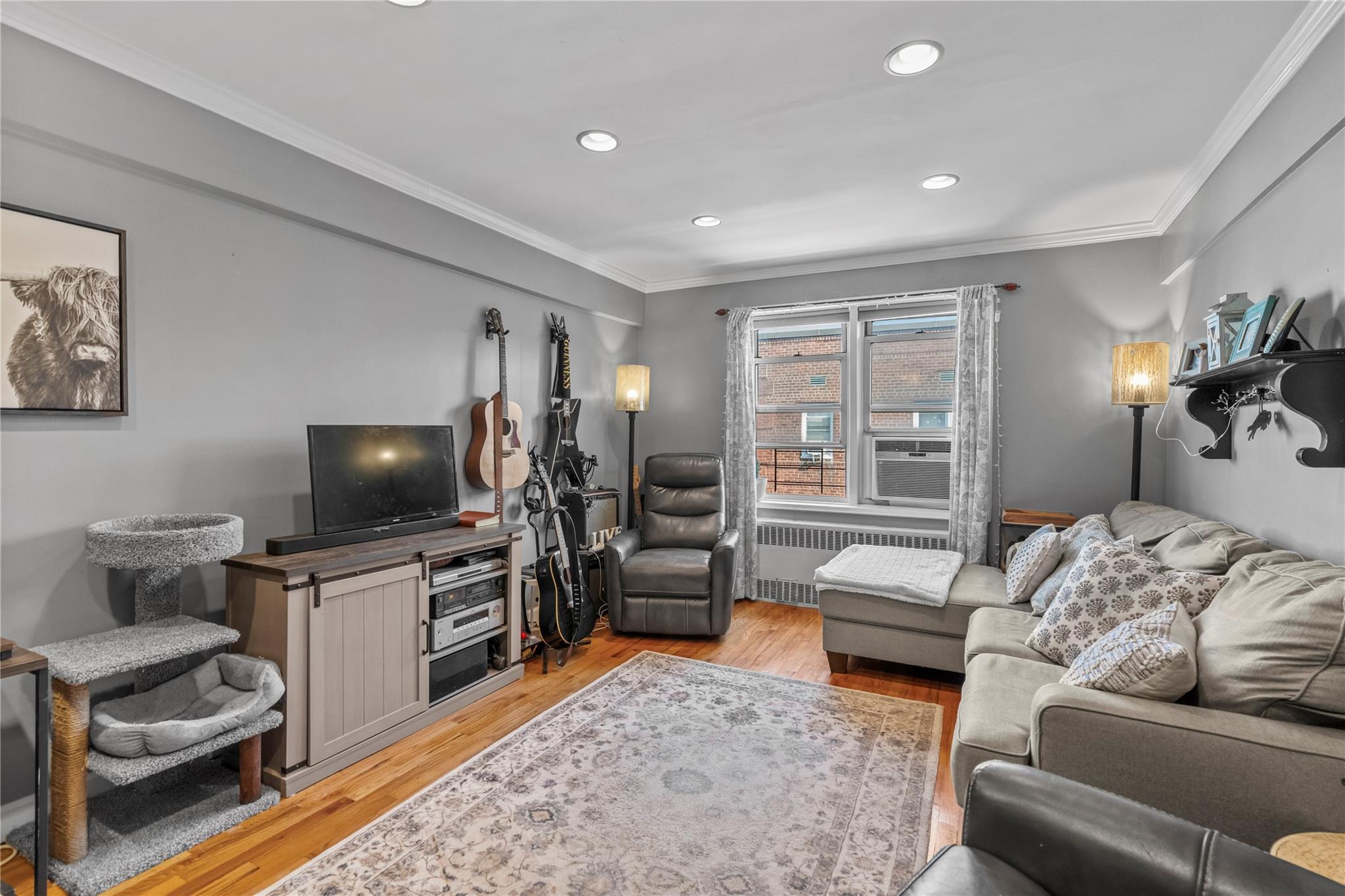 60 Locust Avenue, Unit 610 New Rochelle, NY 10801 - Photo 4 of 22 a living room with furniture and a flat screen tv