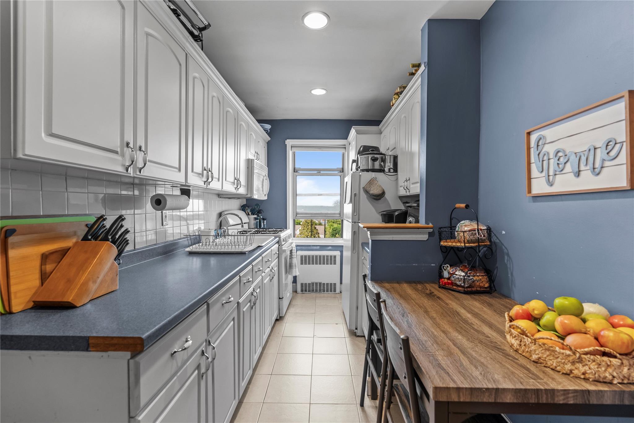 60 Locust Avenue, Unit 610 New Rochelle, NY 10801 - Photo 8 of 22 a kitchen with stainless steel appliances granite countertop a sink stove and refrigerator