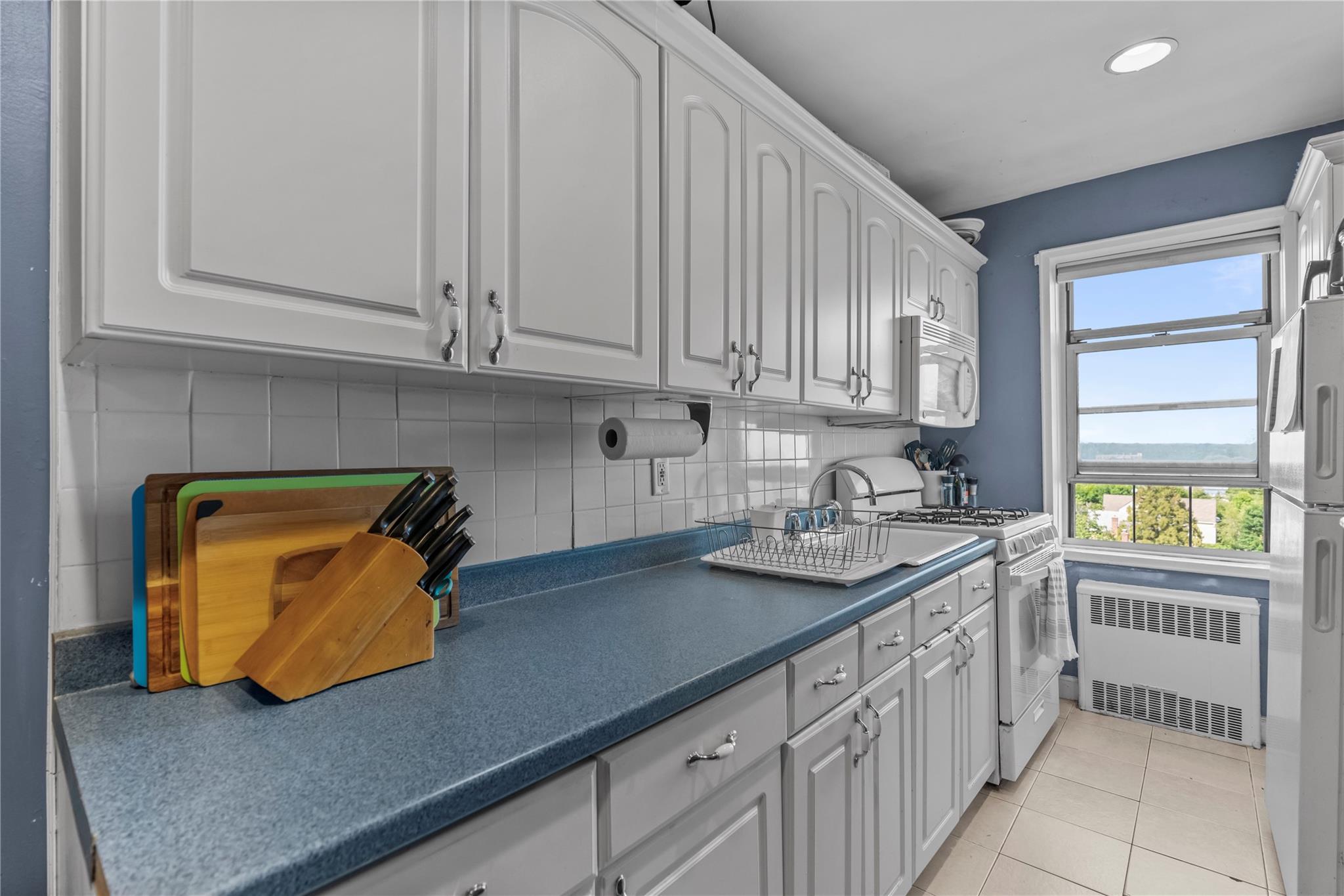 60 Locust Avenue, Unit 610 New Rochelle, NY 10801 - Photo 9 of 22 a kitchen with stainless steel appliances granite countertop a sink and dishwasher with wooden floor