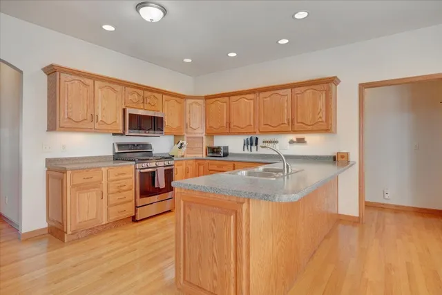 a kitchen with granite countertop a stove top oven and sink