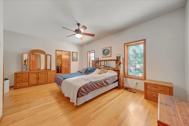 a bedroom with a large bed and a chandelier