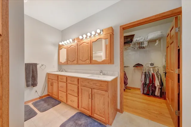 a bathroom with a double vanity sink and a mirror
