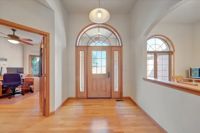 a view of hall way with furniture and windows