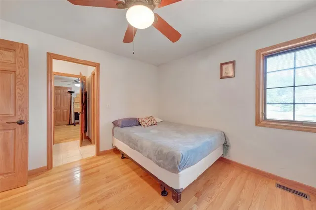 a bedroom with a bed and a chandelier