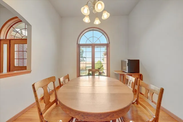 a view of a dining room with furniture and a window