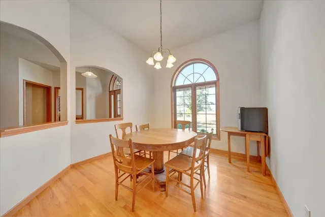 a view of a dining room with furniture and chandelier