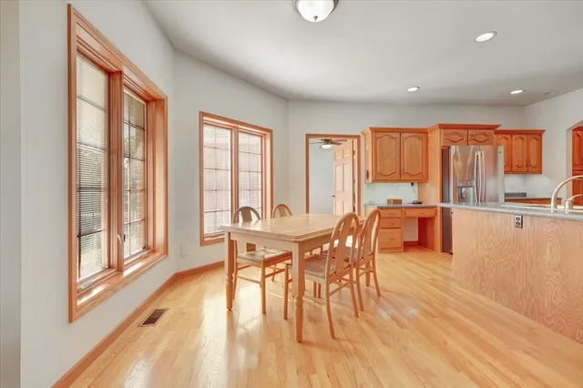 a dining room with furniture a chandelier and wooden floor