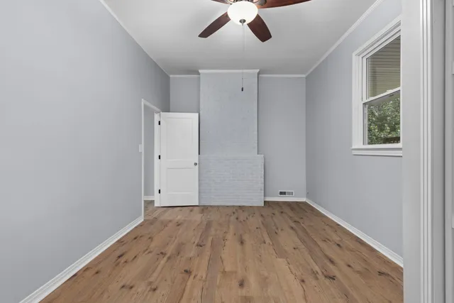 wooden floor in an empty room with a window