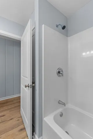 a bathroom with a tub shower and vanity