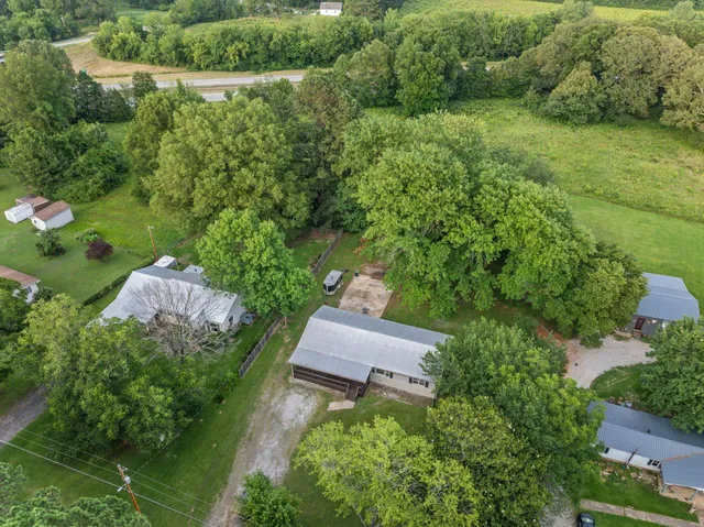 an aerial view of a house with yard