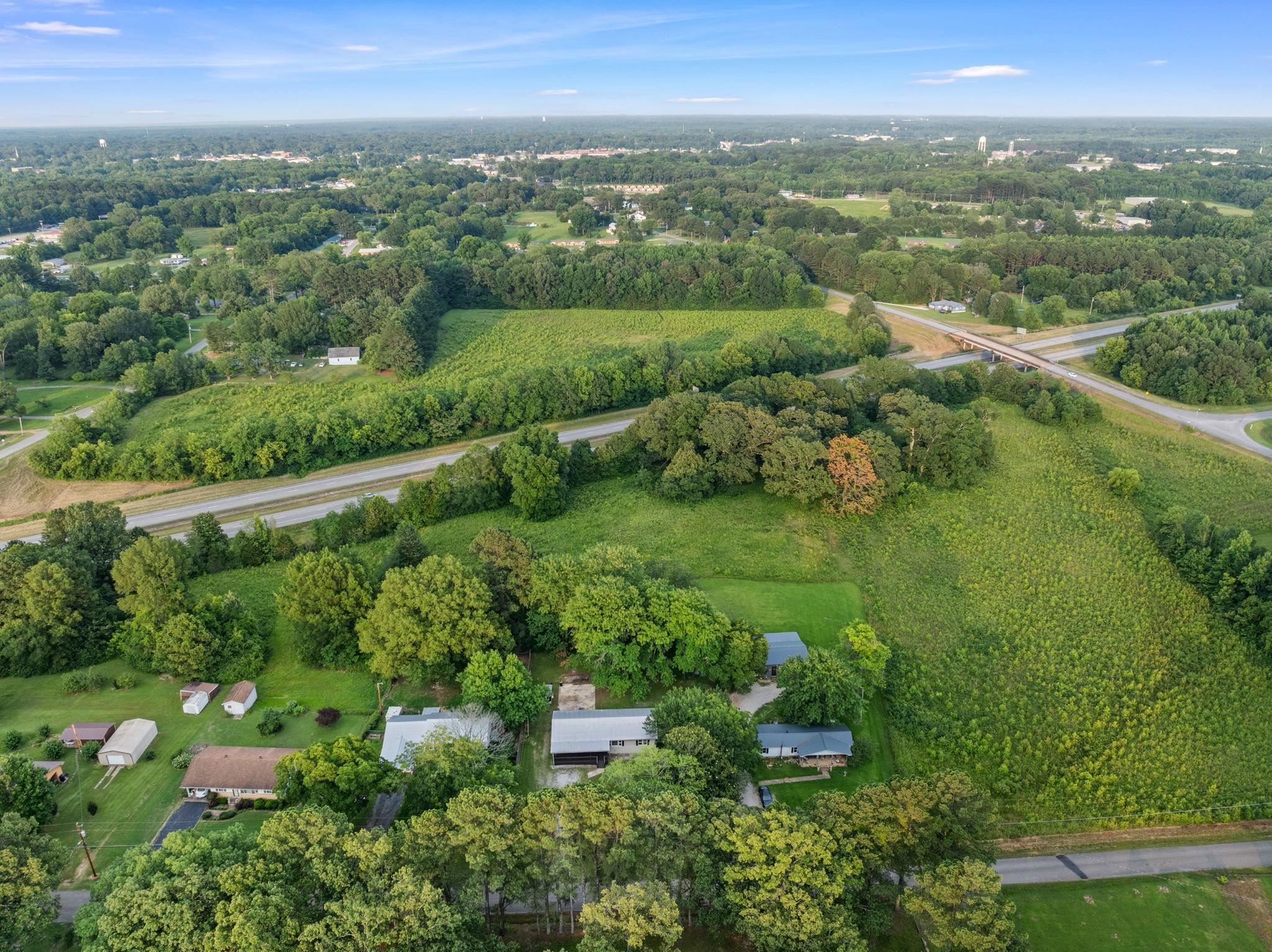 505 Mckewen Road Corinth, MS 38834 - Photo 36 of 39 an aerial view of green landscape with trees houses and lake view