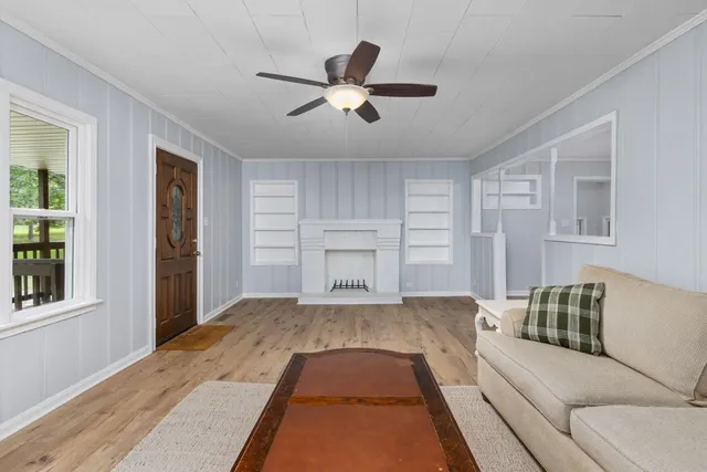 a living room with a bed furniture and a window