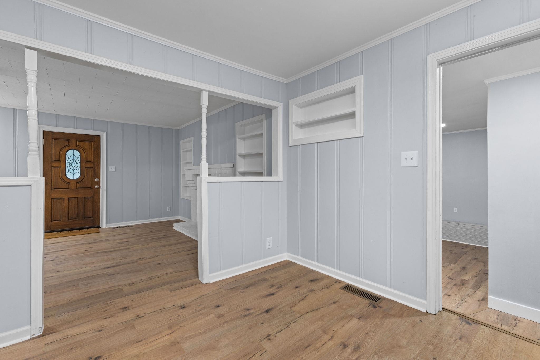 505 Mckewen Road Corinth, MS 38834 - Photo 5 of 39 an empty room with wooden floor and windows