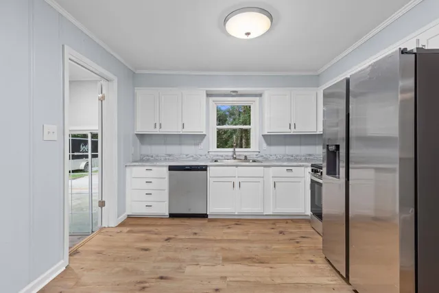 a kitchen with a refrigerator stove and sink