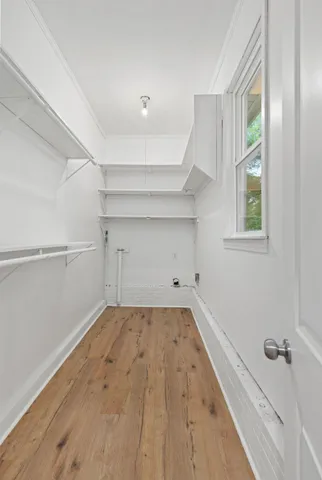 a view of a big room with closet and windows