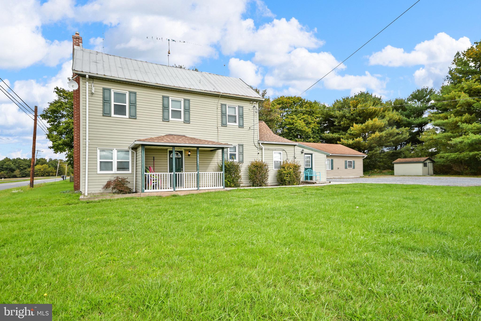 9604 Dry Bridge Road Emmitsburg, MD 21727 - Photo 2 of 11 a front view of a house with a garden