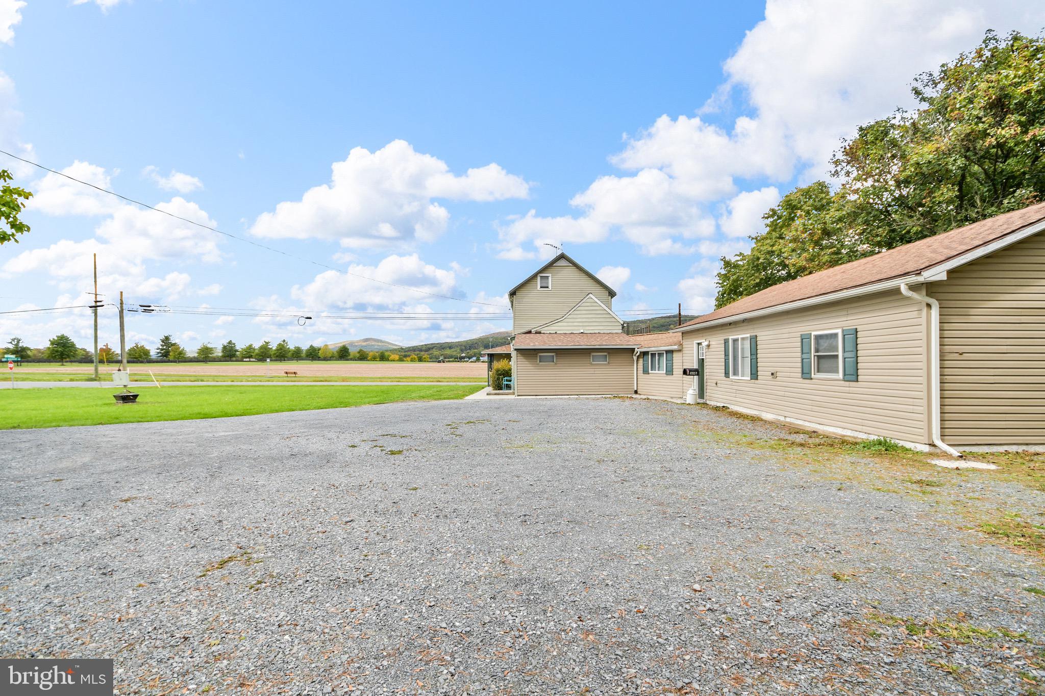 9604 Dry Bridge Road Emmitsburg, MD 21727 - Photo 6 of 11 a view of a house with a yard and a large tree