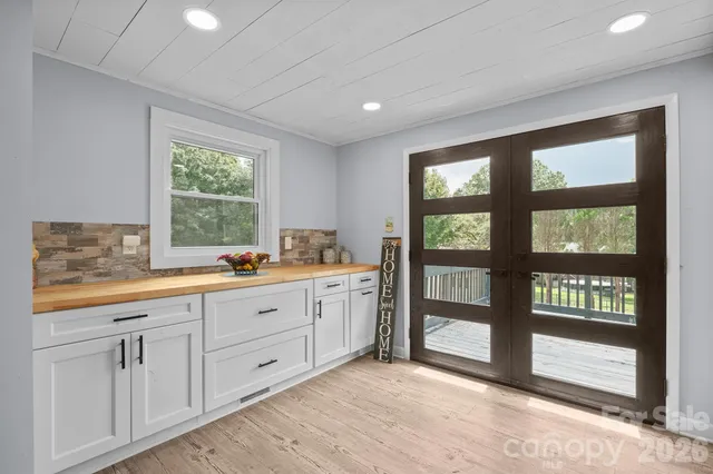a spacious bathroom with double vanity and a large window