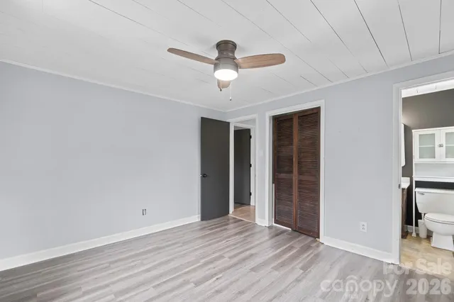 a view of empty room with wooden floor