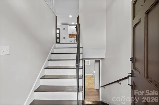 a view of entryway and hall with wooden floor