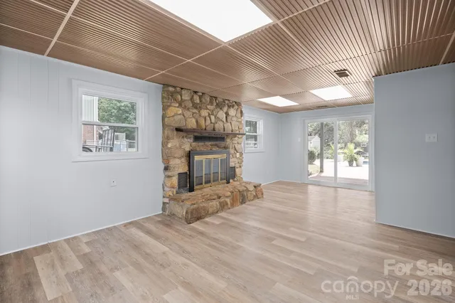 a view of a livingroom with wooden floor and a large window
