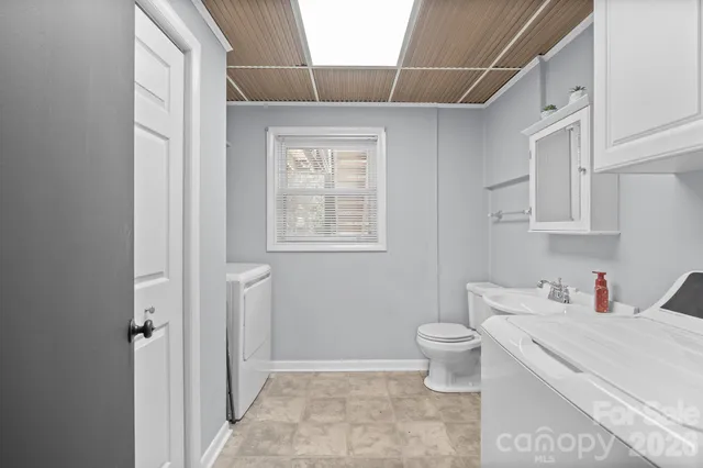 a bathroom with a sink toilet vanity and tub